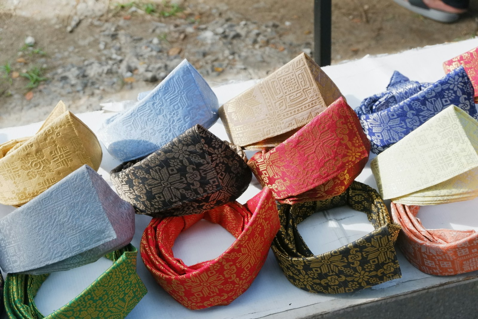 A table topped with lots of different colored ties